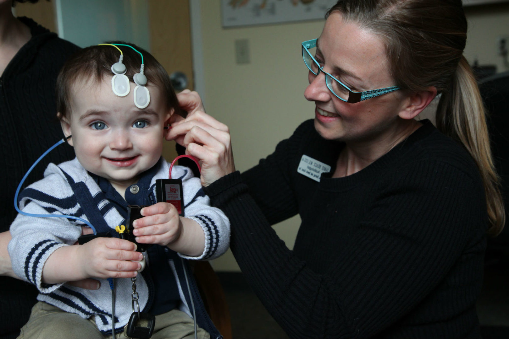 Doctor doing hearing exam.